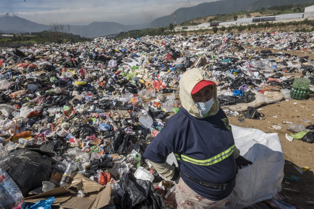 Con el rostro tapado por la contaminación del lugar, Dolores trabaja desde horas de la mañana para llevar sustento a su hogar. Foto: Edwin Bercián