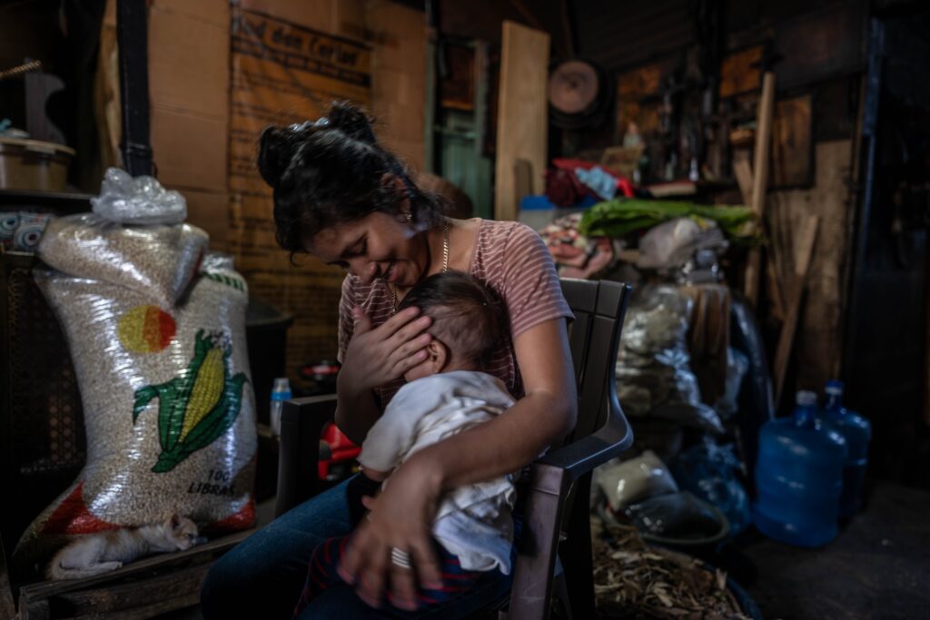 Lesly Colop sonríe mientras acaricia a su hijo Thiago de un año, quien logró recuperarse de desnutrición aguda severa. Foto: Edwin Bercián