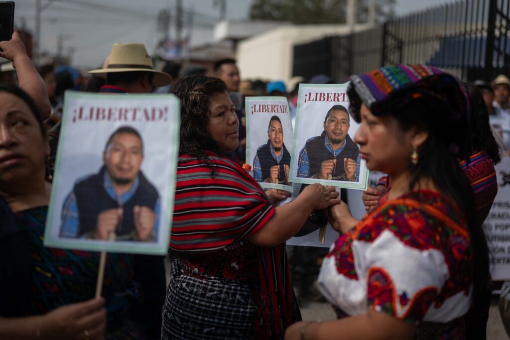 Muejeres sostienen los retratos del dirigente indígena, Héctor Chaclán, capturado hace un año por defender la democracia. Foto/Edwin Bercián
